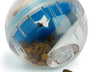 Interactive treat dispensing ball for dogs that slows feeding and provides mental stimulation through engaging play.