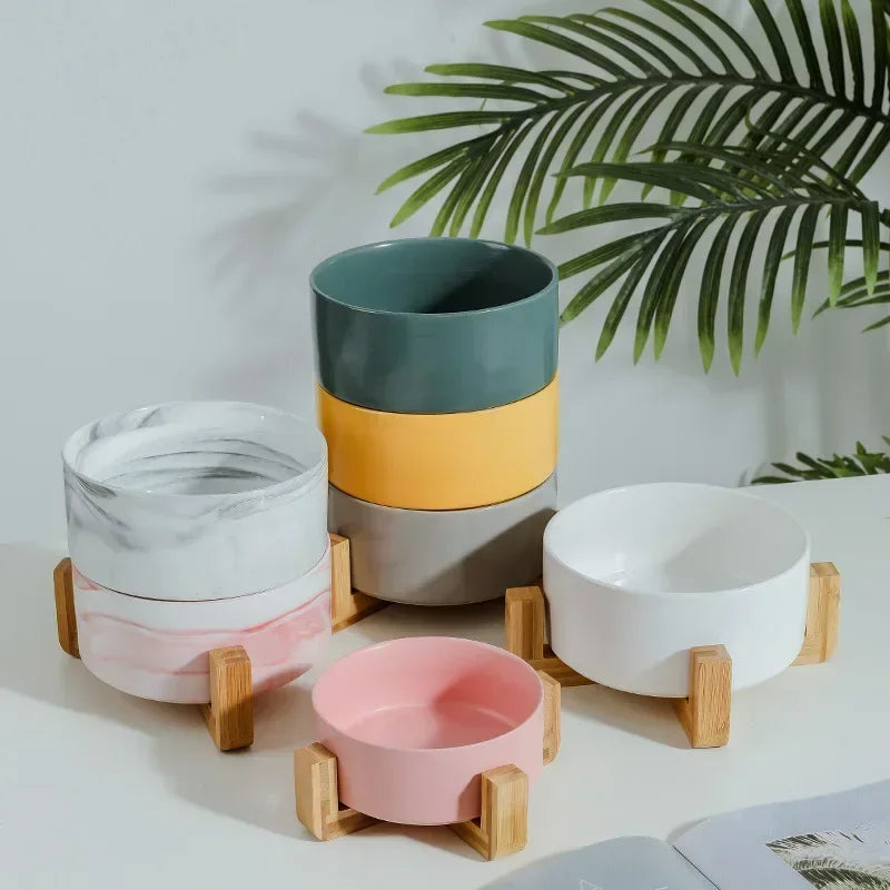 Elevated ceramic pet bowl with wooden frame for dogs and cats, promoting healthy posture and comfortable feeding"